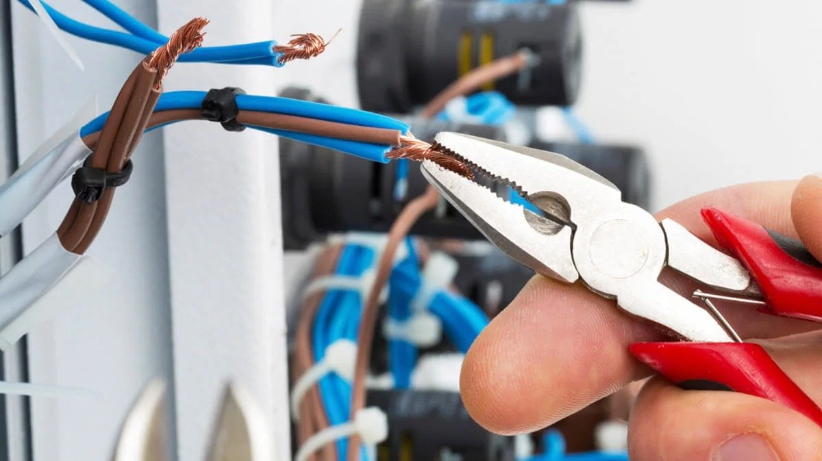 Close-up of electrical repair work on wiring inside a panel
